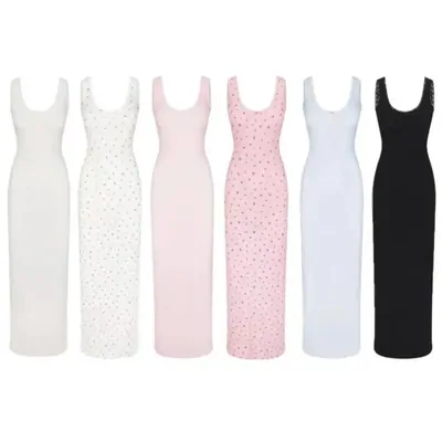 Six slip dresses laid flat in a row, in white, blush, patterned pink and black